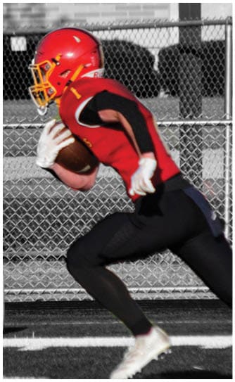 A football player catching a ball. Description generated by AI