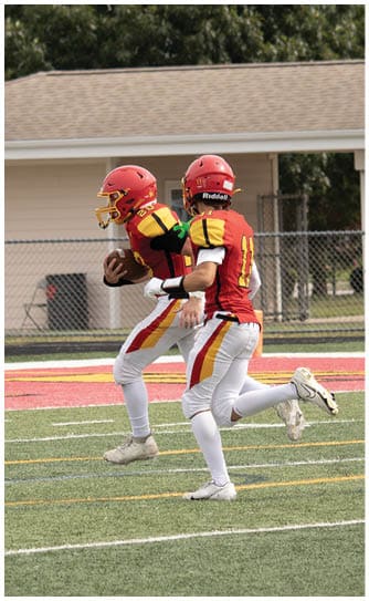 A football player catching a ball. Description generated by AI