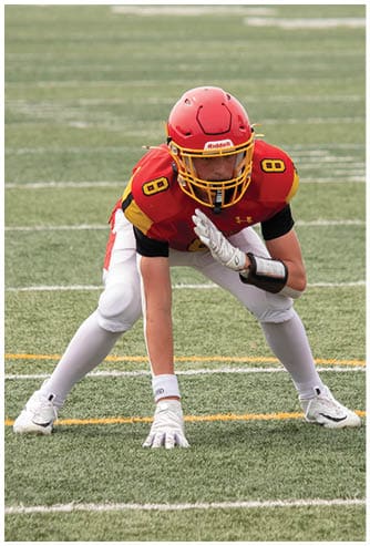 A football game is being played on a field. Description generated by AI