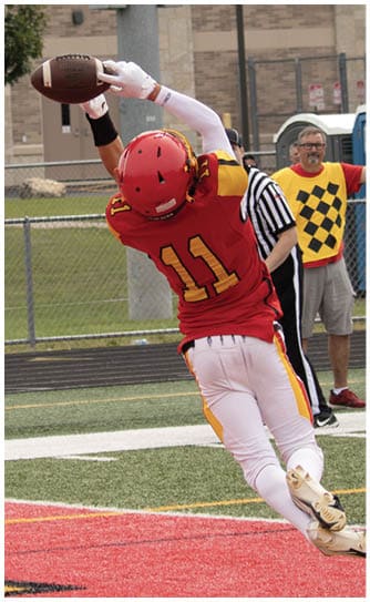 A football player catching a ball. Description generated by AI