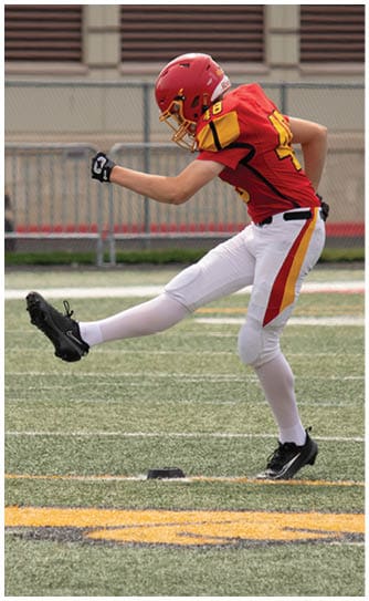 A football player catching a ball. Description generated by AI