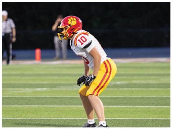 A football player running on the field. Description generated by AI