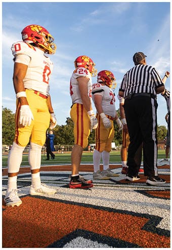 A group of football players celebrating a touchdown. Description generated by AI