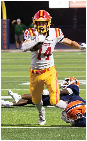Two football players wearing blue and white uniforms. Description generated by AI