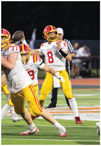 A group of football players celebrating a touchdown. Description generated by AI