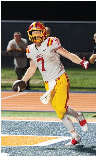 Two football players wearing blue and white uniforms. Description generated by AI