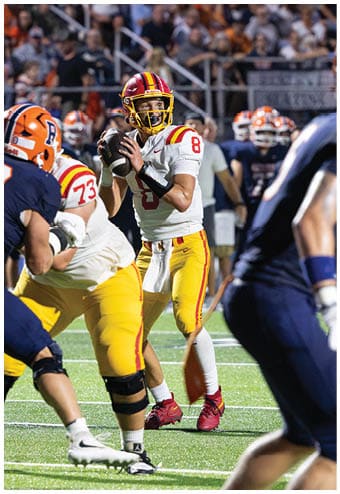 A group of football players celebrating a touchdown. Description generated by AI