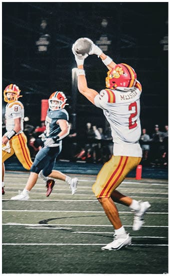 Two football players wearing blue and white uniforms. Description generated by AI