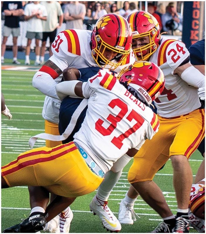 A group of football players on a field. Description generated by AI