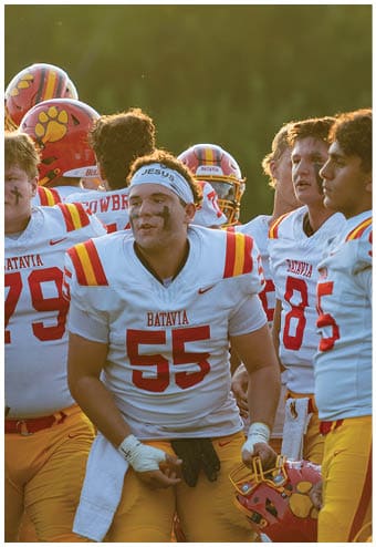 A group of football players celebrating a touchdown. Description generated by AI