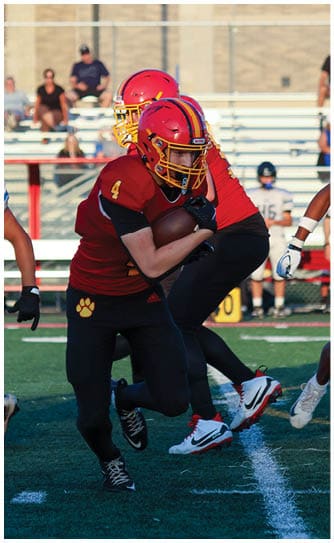 A football player catching a ball. Description generated by AI