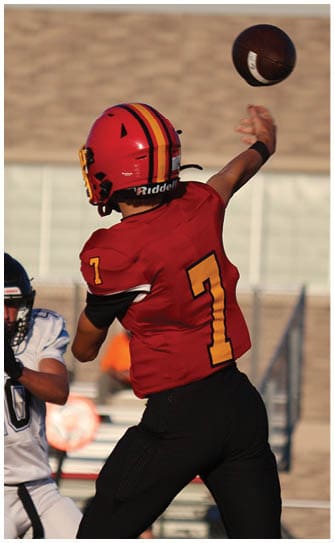 A football player catching a ball. Description generated by AI