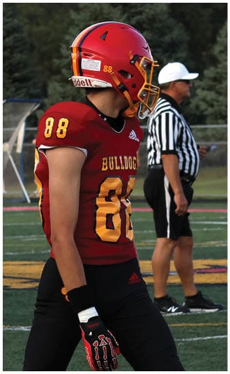 A football player catching a ball. Description generated by AI