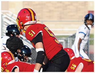 A group of football players on a field. Description generated by AI