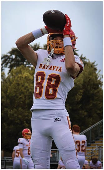 A football player catching a ball. Description generated by AI