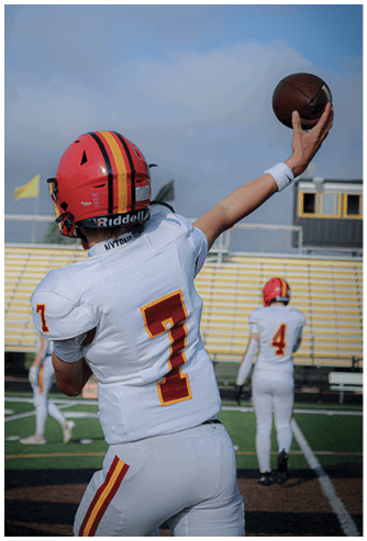 A football game is being played on a field. Description generated by AI