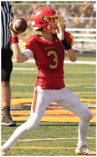 A football player catching a ball. Description generated by AI