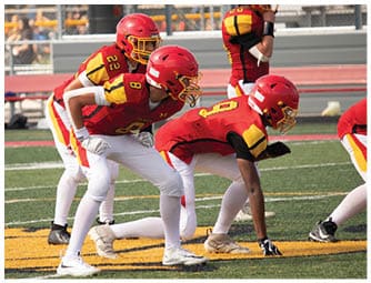 A group of football players on a field. Description generated by AI