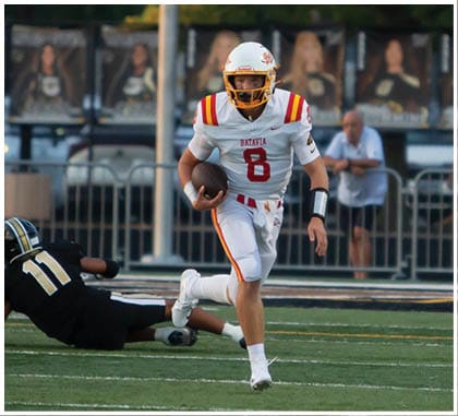 A football player running on the field. Description generated by AI