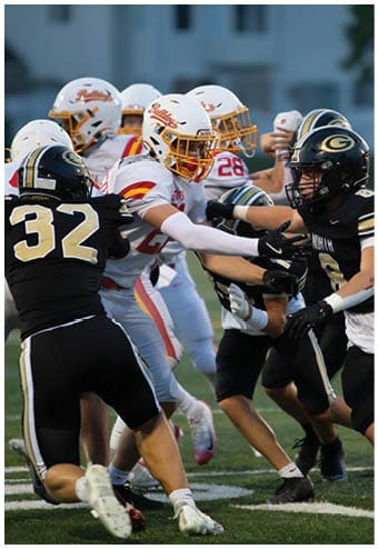 A group of football players celebrating a touchdown. Description generated by AI