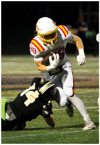 A group of football players celebrating a touchdown. Description generated by AI