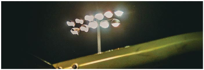 A football game is taking place on a field with players wearing blue and white uniforms. Description generated by AI