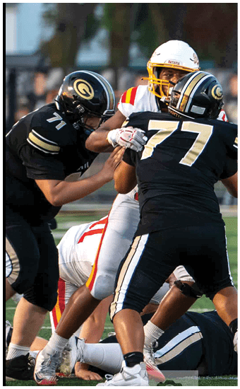 Two football players wearing blue and white uniforms. Description generated by AI