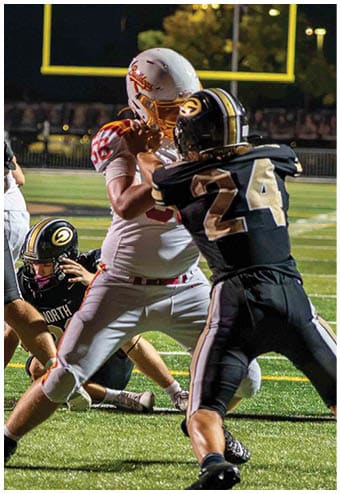 A group of football players celebrating a touchdown. Description generated by AI