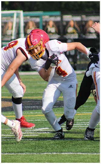 A football player catching a ball. Description generated by AI