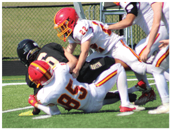 A group of football players on a field. Description generated by AI