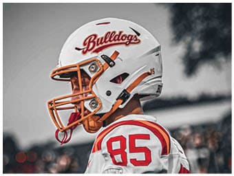 A football player running on the field. Description generated by AI