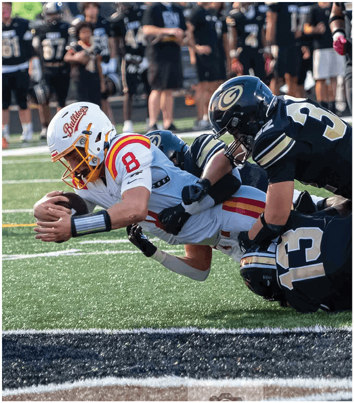 A group of football players on a field. Description generated by AI