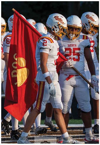 A group of football players celebrating a touchdown. Description generated by AI