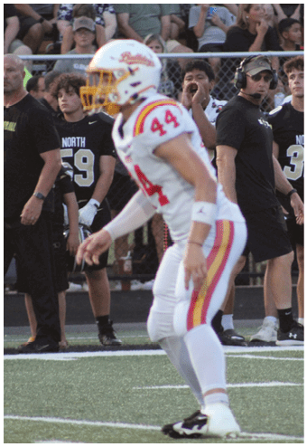 A group of football players celebrating a touchdown. Description generated by AI