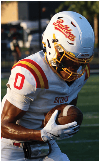 Two football players wearing blue and white uniforms. Description generated by AI