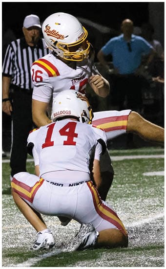 Two football players wearing blue and white uniforms. Description generated by AI