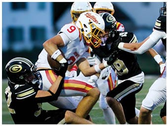 A football player running on the field. Description generated by AI