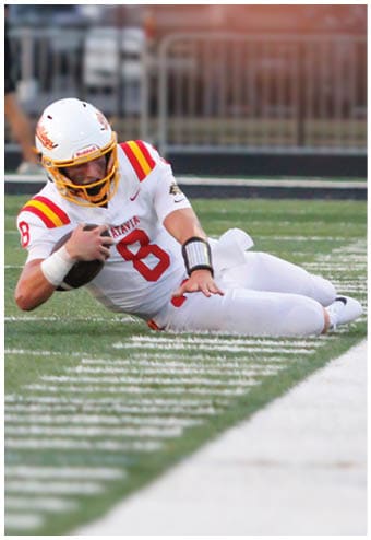 A group of football players celebrating a touchdown. Description generated by AI