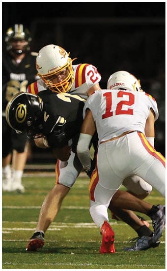Two football players wearing blue and white uniforms. Description generated by AI