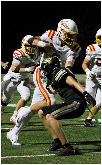 Two football players wearing blue and white uniforms. Description generated by AI