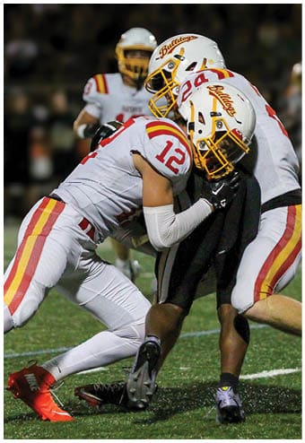 A group of football players celebrating a touchdown. Description generated by AI
