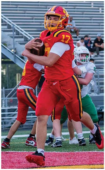 Two football players wearing blue and white uniforms. Description generated by AI
