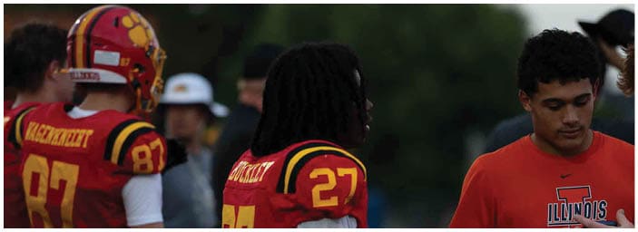 A group of football players on a field. Description generated by AI
