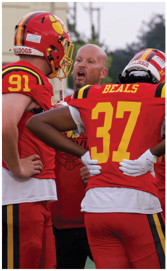 Two football players wearing blue and white uniforms. Description generated by AI
