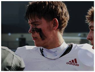 A group of football players on a field. Description generated by AI