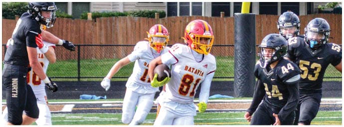 A football player wearing a blue and white uniform. Description generated by AI