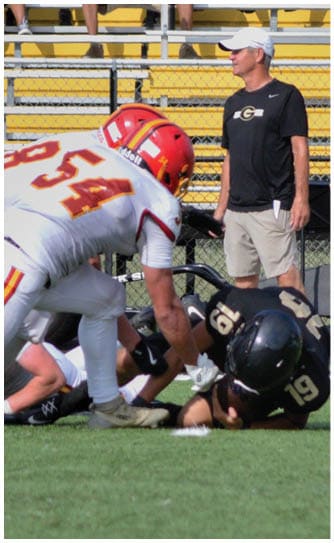 A football player catching a ball. Description generated by AI
