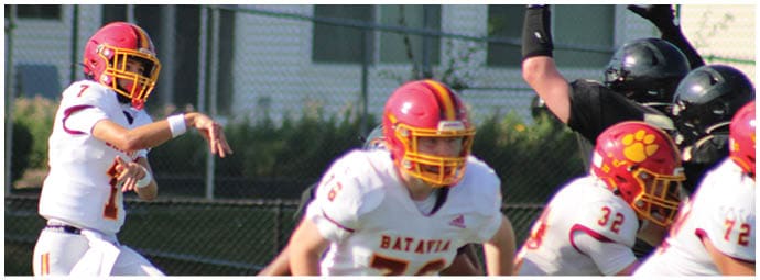 A football player wearing a blue and white uniform. Description generated by AI