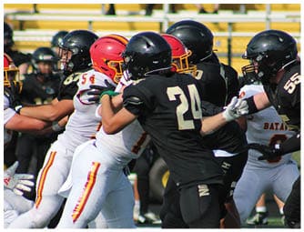 A group of football players on a field. Description generated by AI
