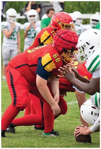A football game is being played on a field. Description generated by AI